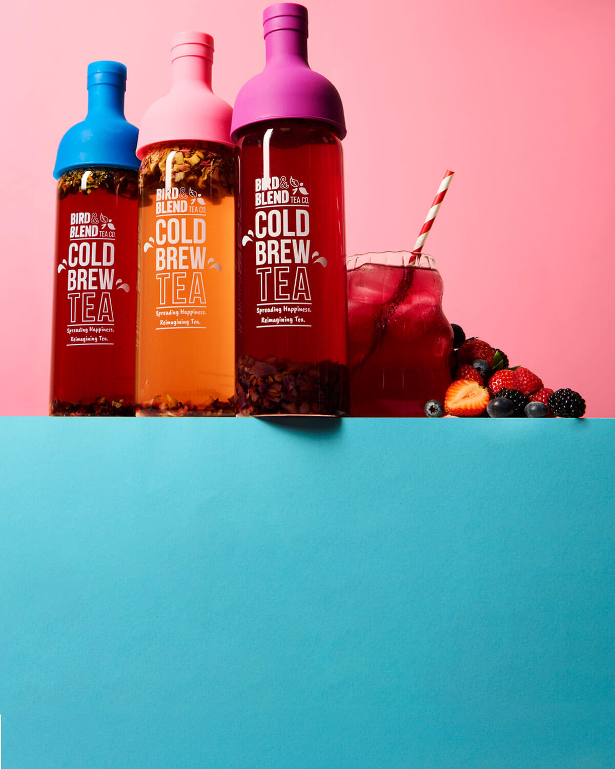 peachy pink plum purple & sapphire blue cold brew tea bottle filled with tea next iced tea
