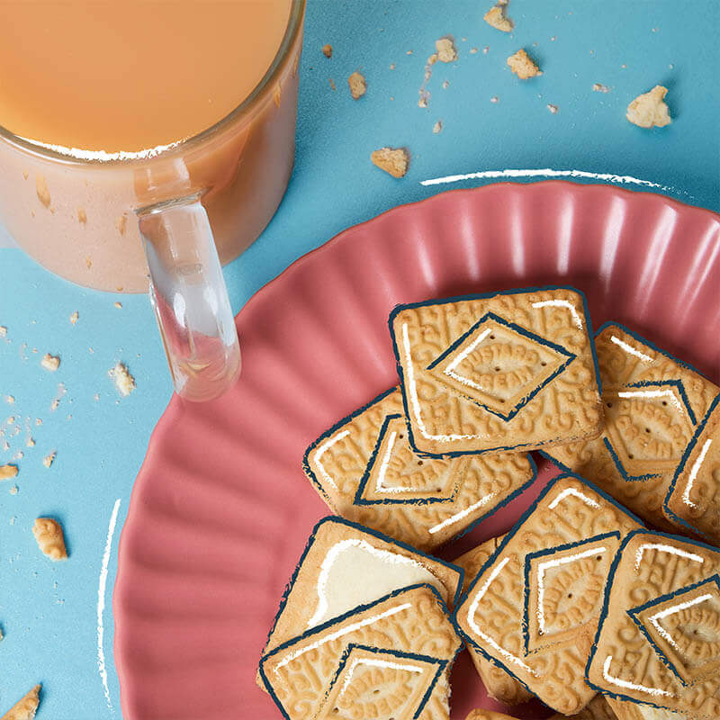 custard cream biscuits and tea on a plate