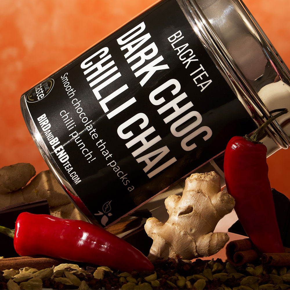 Dark Choc Chili Chai Tea Tin Lying on a Bed of Spices