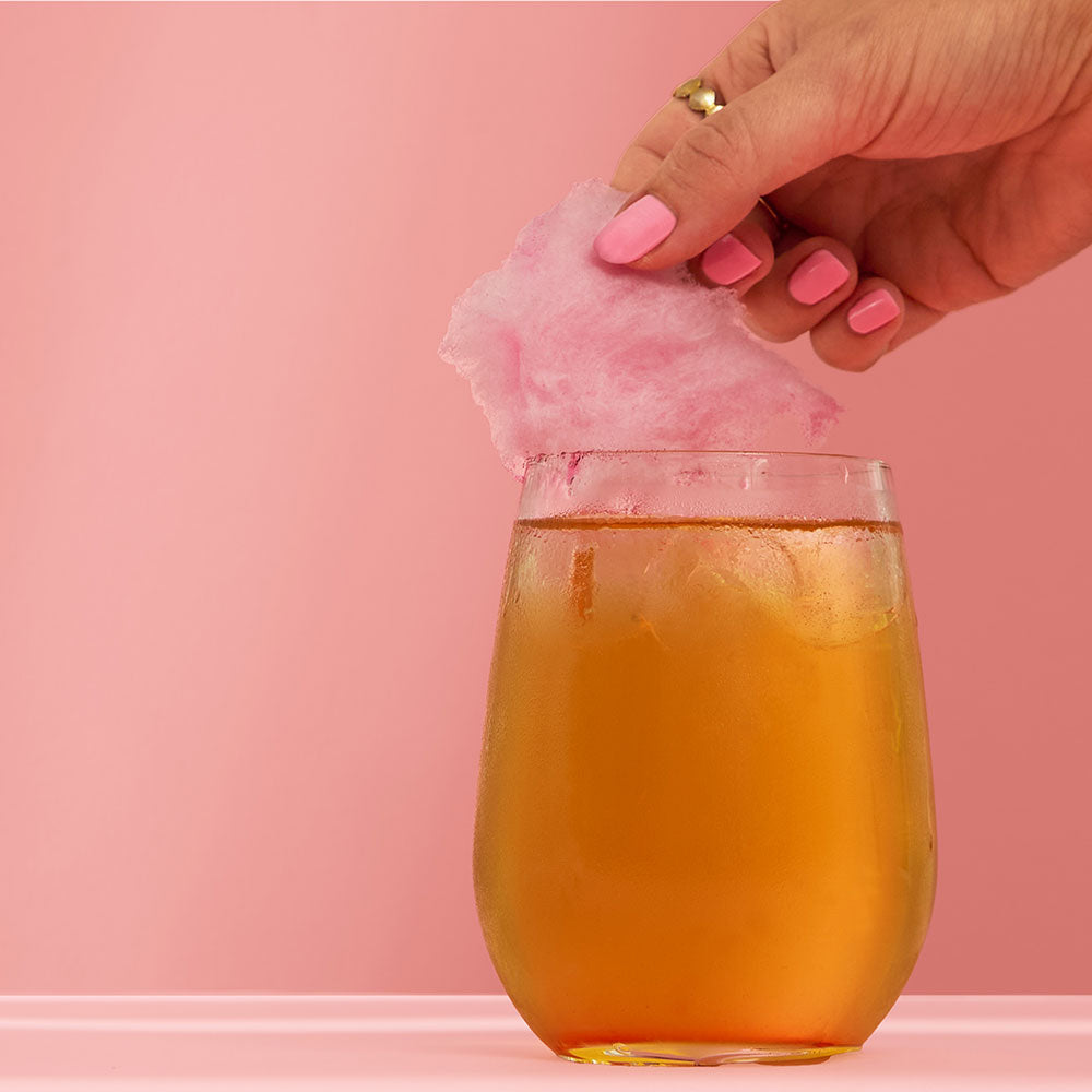 Baby Spice Iced Tea Mocktail With Candy Floss Topper &amp; Hand Picking Up Candy Floss