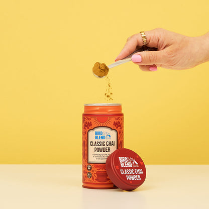Classic Chai Tea Powder Tin &amp; Spoon Sprinkling the Chai Powder