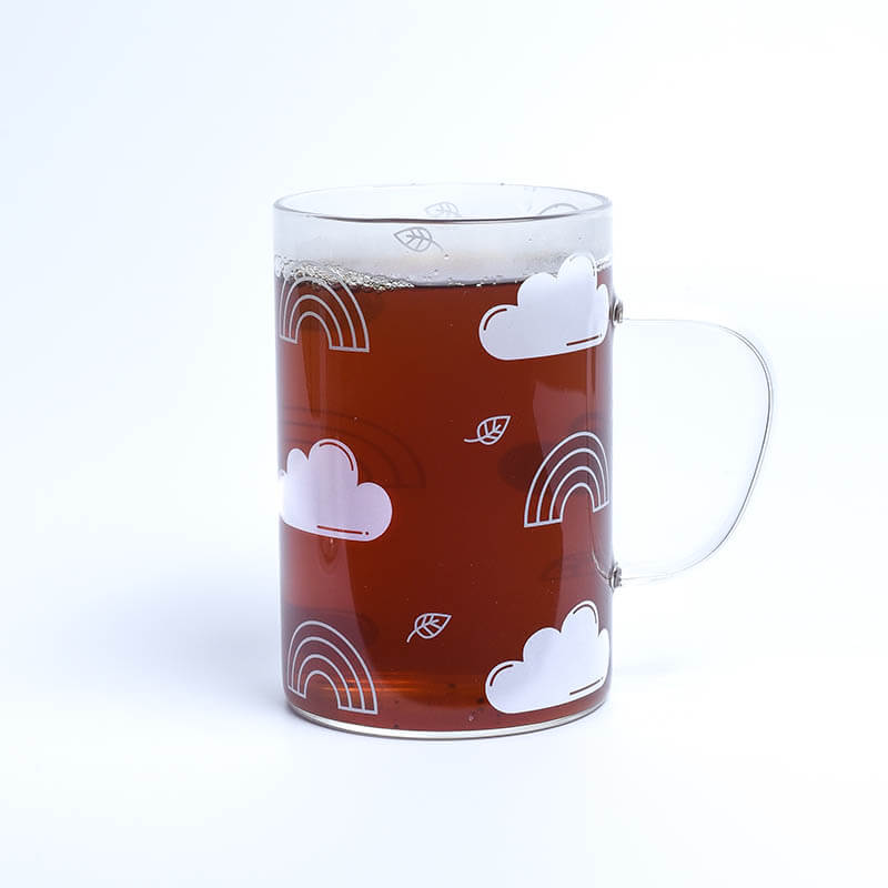 patterned glass mug with tea filled