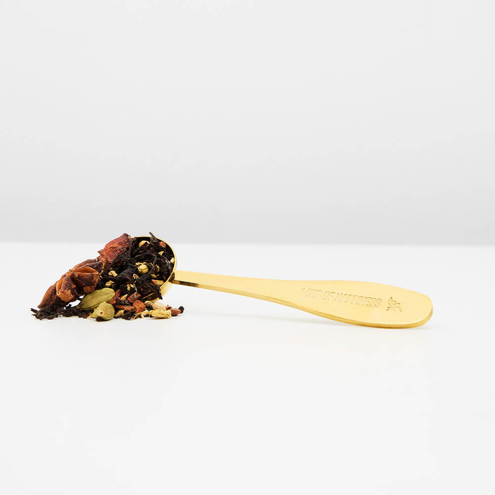 golden tea spoon with loose leaf tea