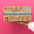 hand holding mystery tea box with pink background