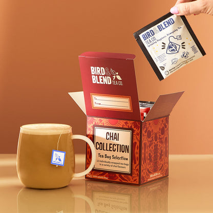 hot chai latte with tea bag in it &amp; chai tea bag gift cube open filled with individually wrapped tea bags &amp; person pulling tea bag out