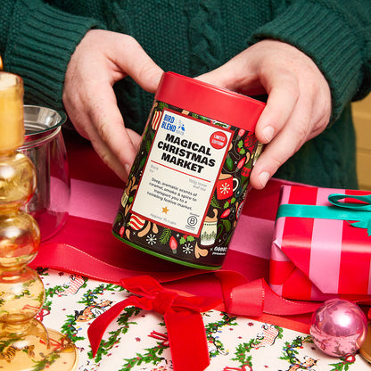 person holding magical Christmas market 150g tea tin
