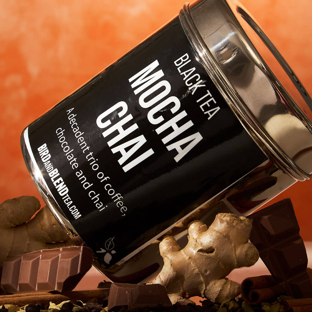  mocha chai custom loose leaf tea tin laying side ways on chocolate & ginger & spices 