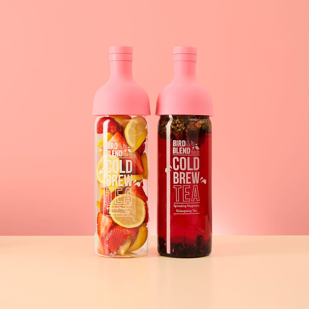 pink cold brew tea bottle with fresh fruit