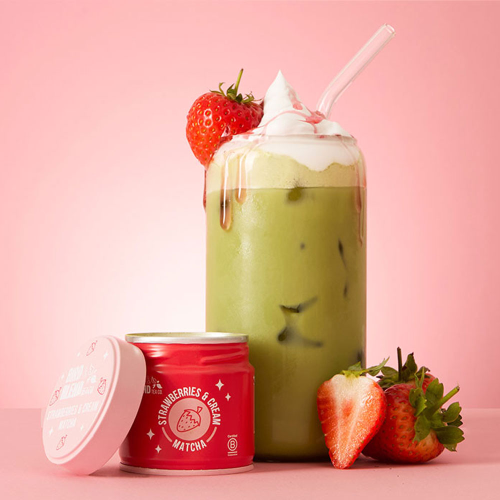 strawberries & cream matcha latte with whipped cream & strawberry sauce & straw & matcha tin